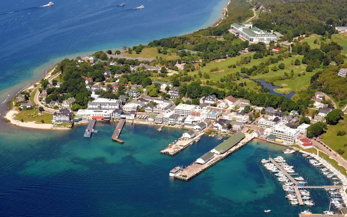 An aerial view of Mackinac Island with the pier on the lake.