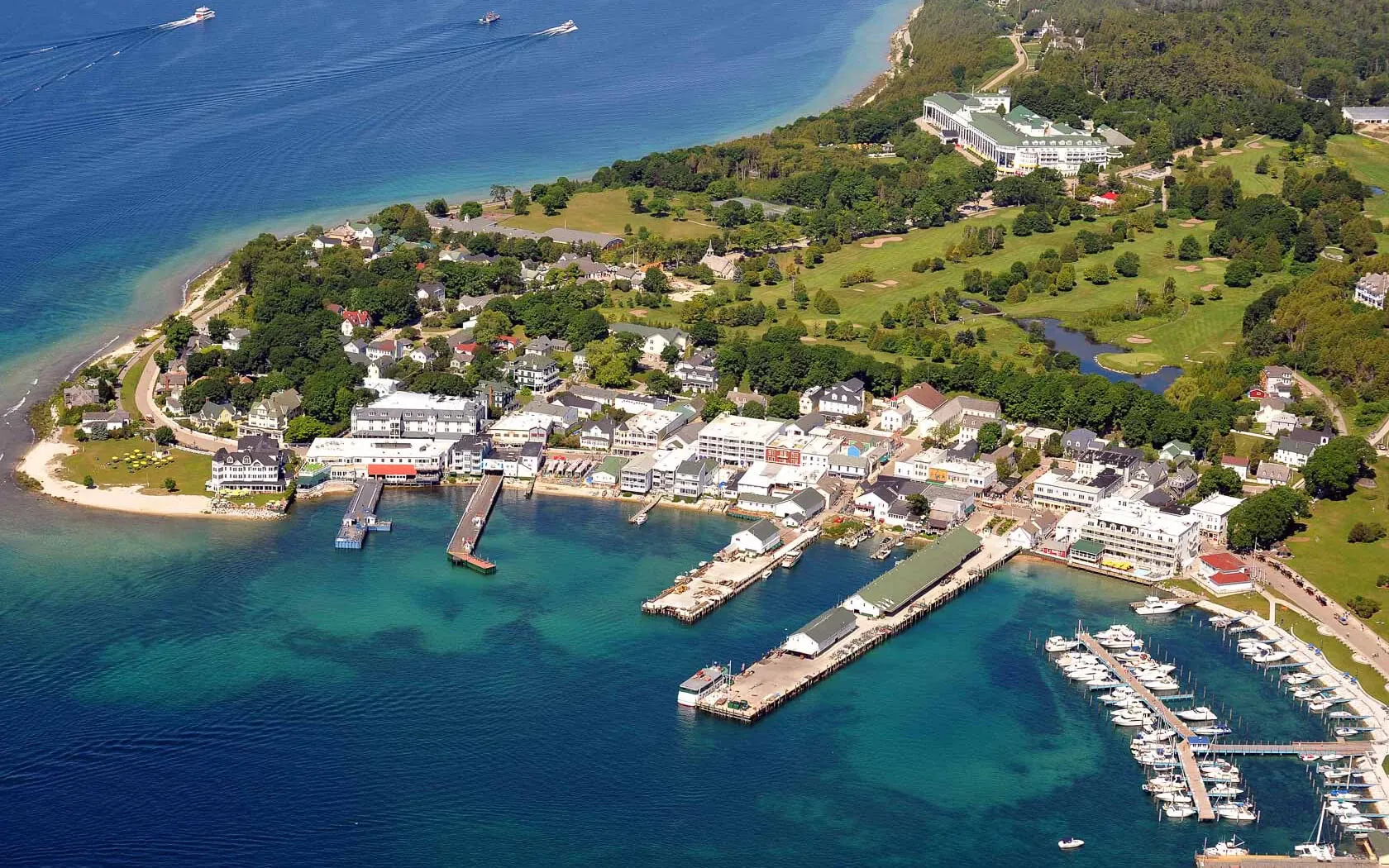 An aerial view of Mackinac Island with the pier on the lake.