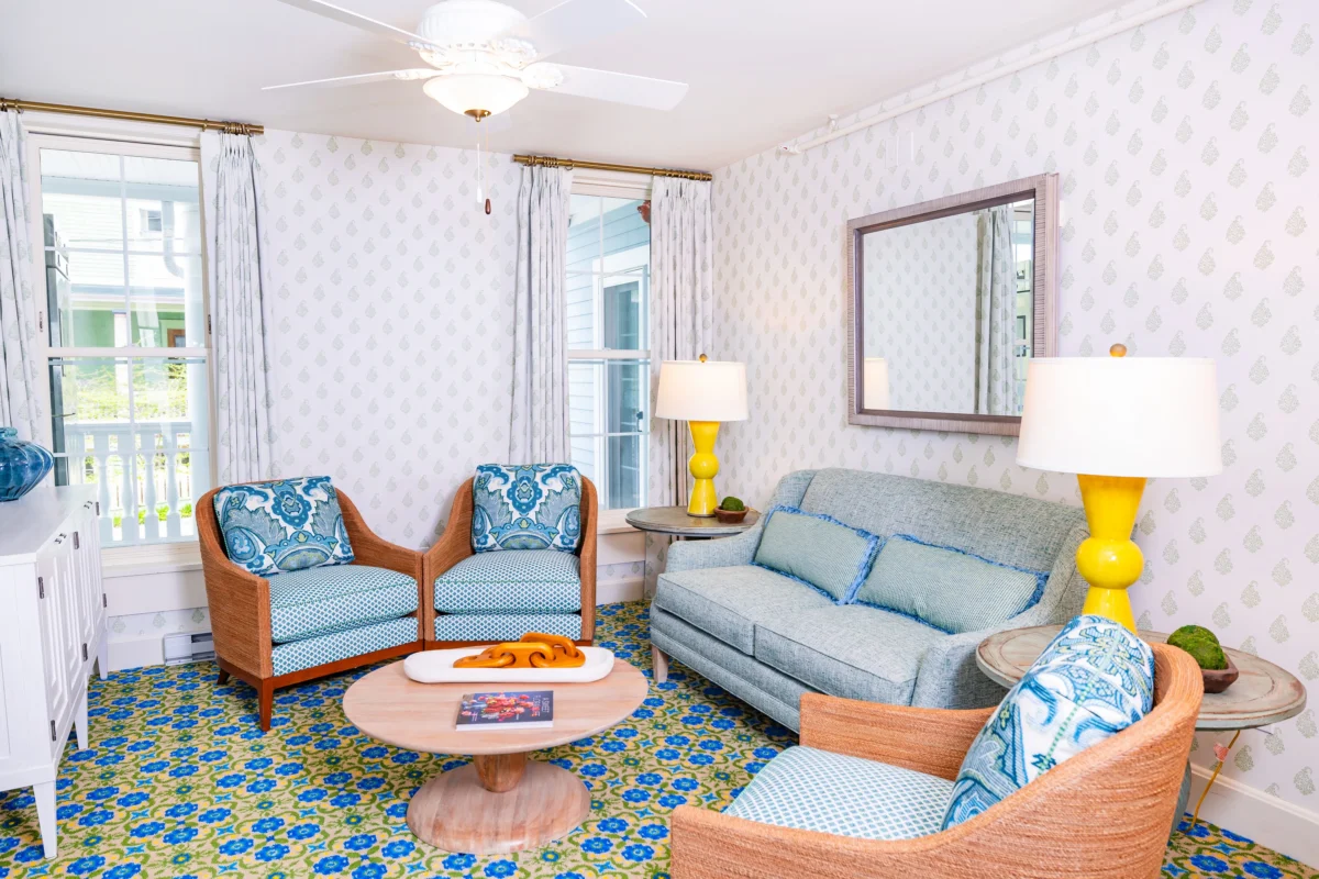 Blue polka dot room with patterned carpet and blue chairs and couches.
