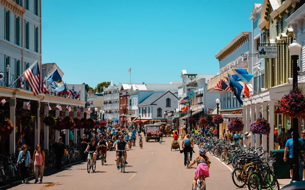 Downtown Mackinac Island on the main street showcasing people riding bikes.