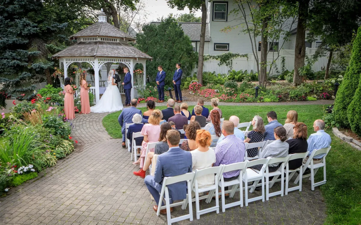 A wedding ceremony showing the guests and the bride and groom.