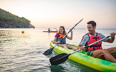 A happy couple taking a kayak tour
